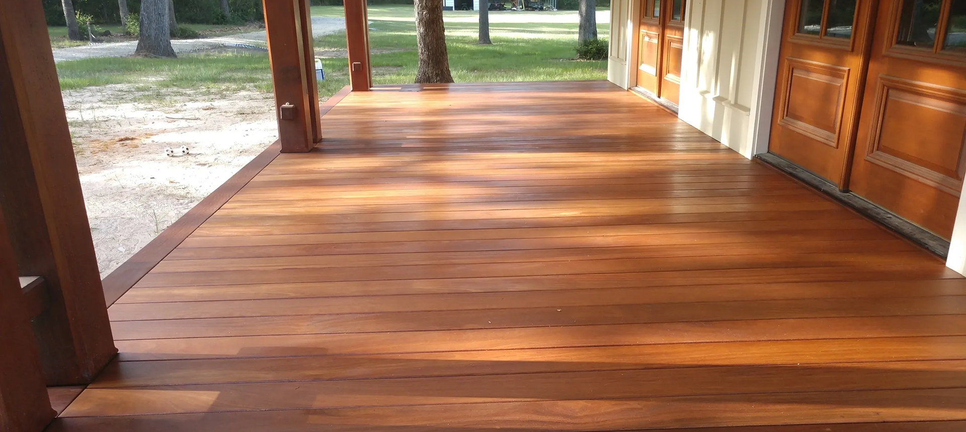Wooden porch with natural surroundings.