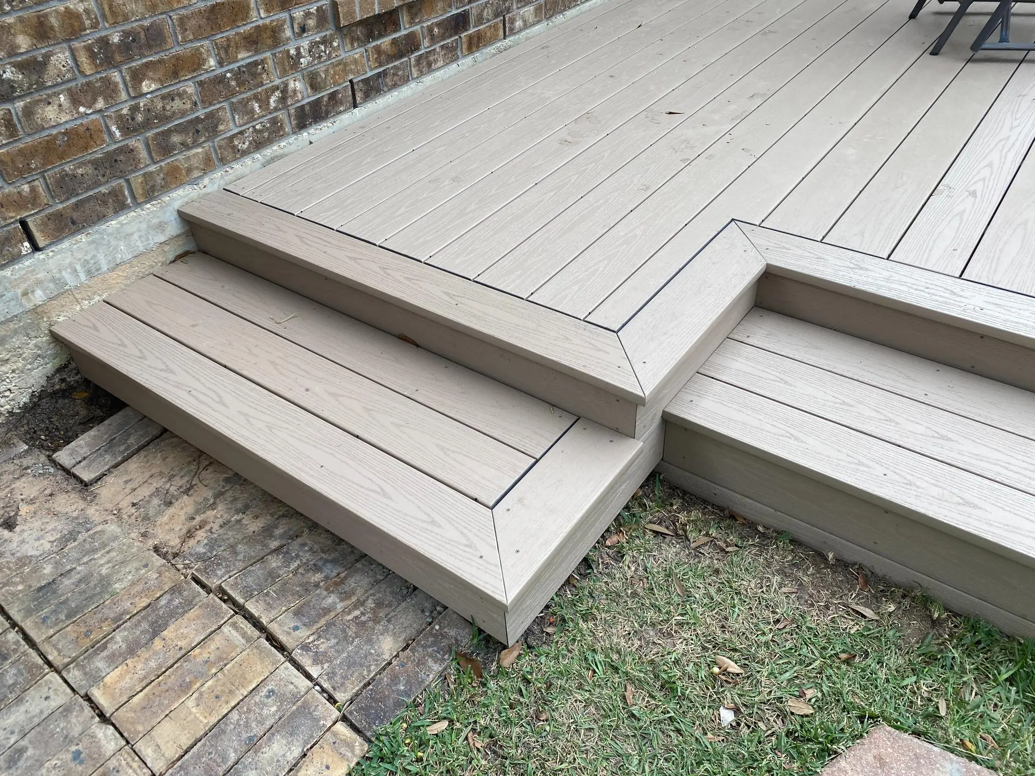 Modern outdoor wooden deck with steps and clean lines.