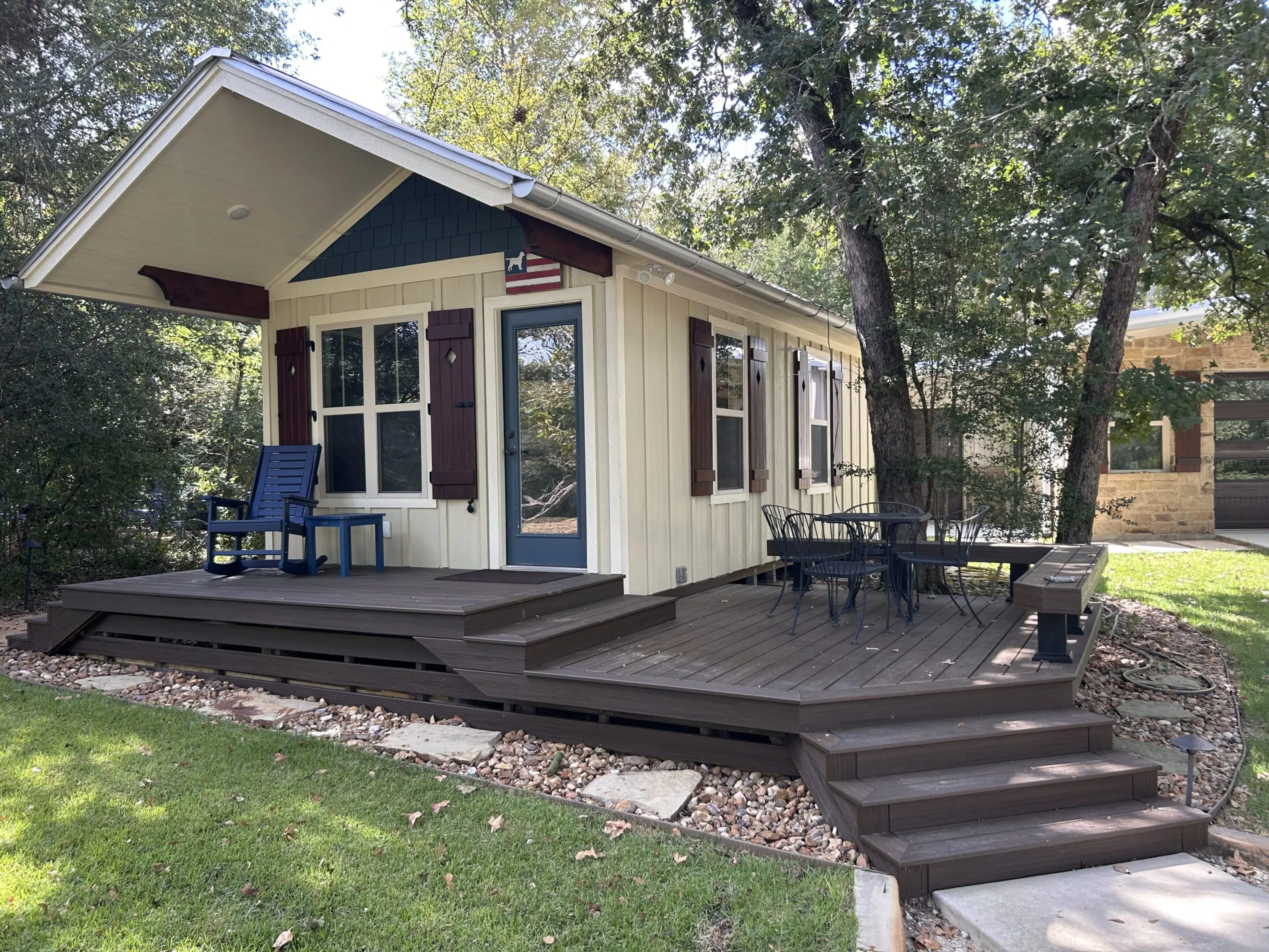 Cozy cabin with a spacious deck surrounded by trees.