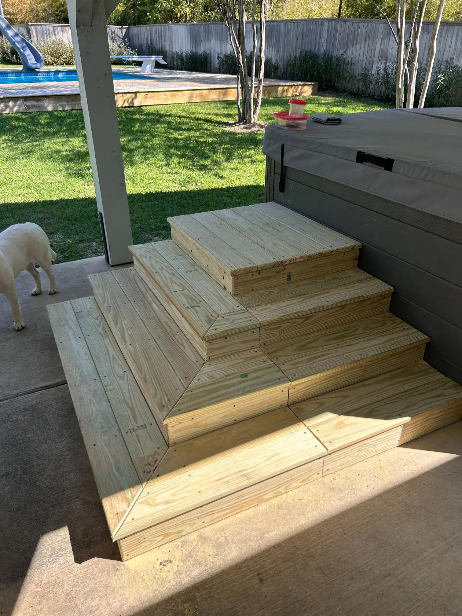 Wooden steps with a multi-level design leading up to a deck.